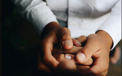 Close up of people holding hands in support