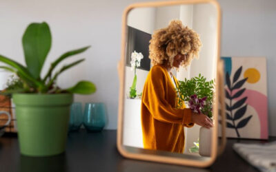 Smiling woman taking care of plants in her house